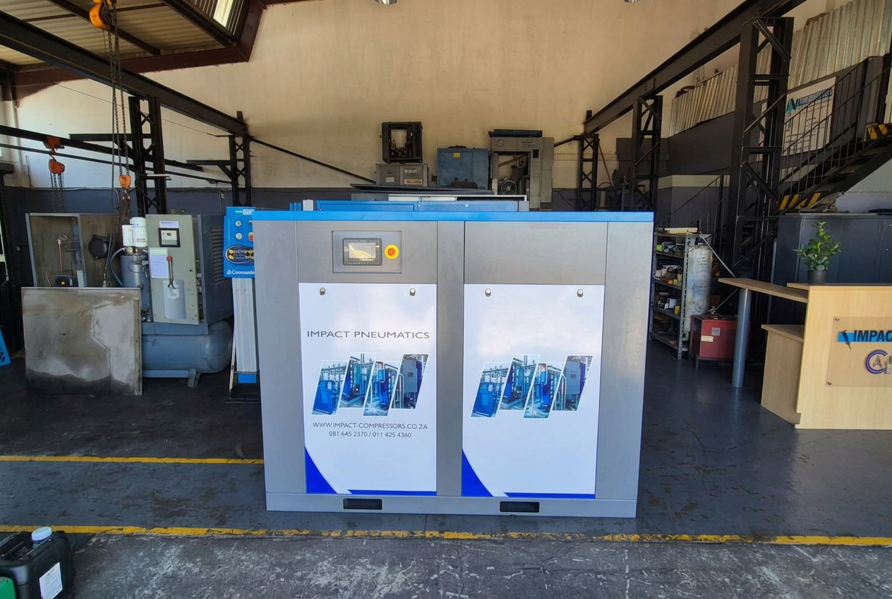 Branded compressor on the floor Impact Pneumatics branded cabinet compressor on the workshop floor undergoing a pre-dispatch quality check